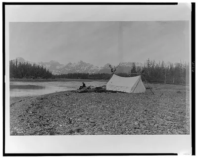 [A man, possibly B.E. Fernow, seated next to river, tent on the…, Alaska, 1899