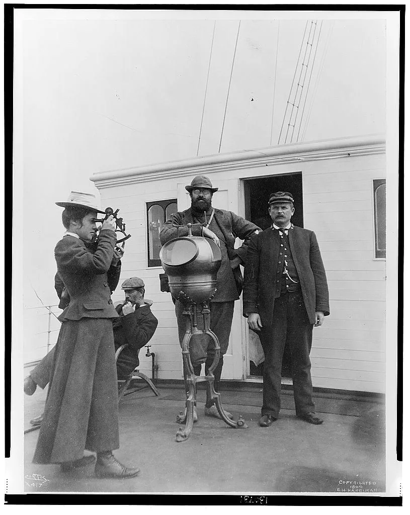 [Woman looking through sextant on board the expedition vessel, George…, Alaska, 1899
