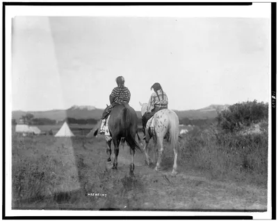 [Two daughters of a chief on horseback, riding away from camera…, 1907