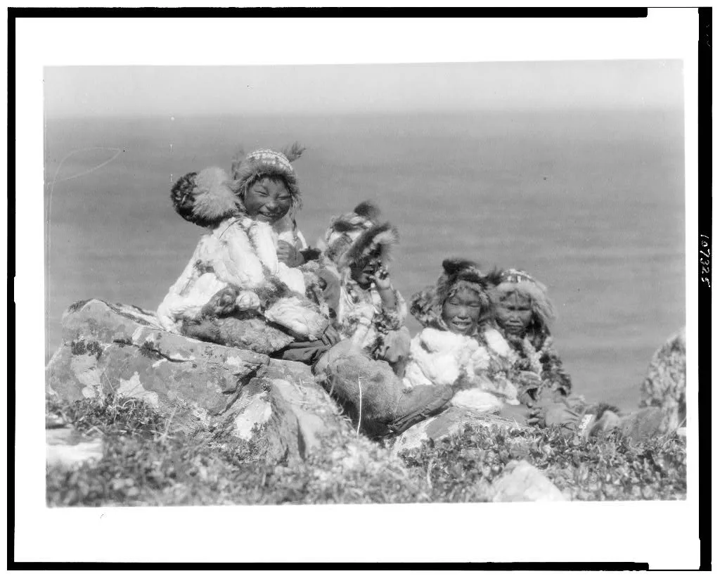 [Four Eskimo children, at edge of cliff, in holiday costume, Nunivak,…, Alaska, Nunivak, 1929