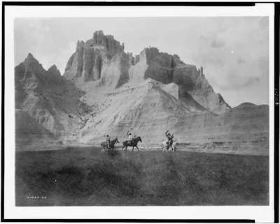 [Entering the Bad Lands.  Three Sioux Indians on horseback], 1905