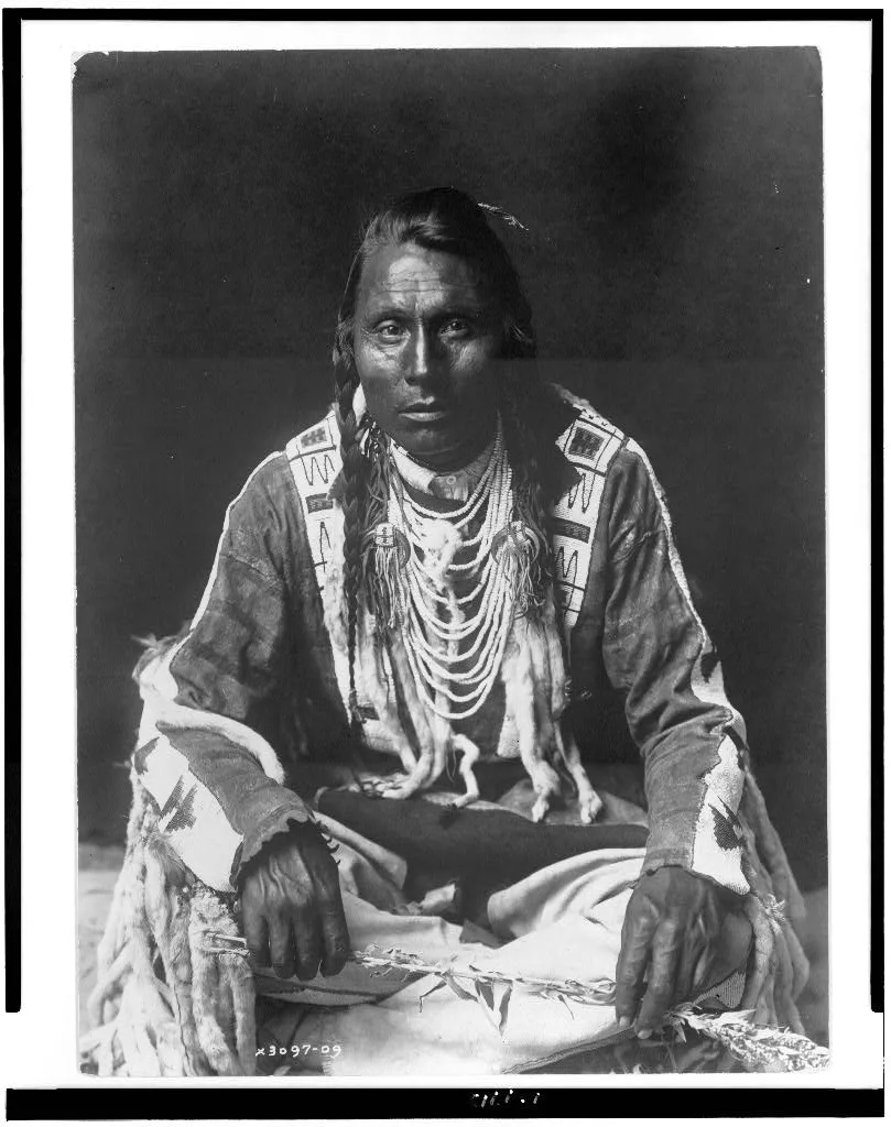[Wades in Water, Piegan Indian, full-length portrait, seated on…, 1910